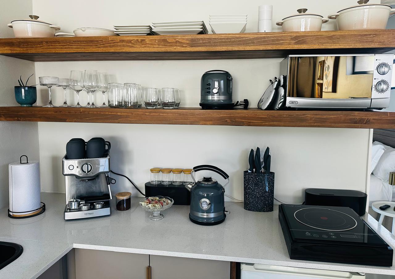 Kitchen shelves with crockery, glasses and appliances